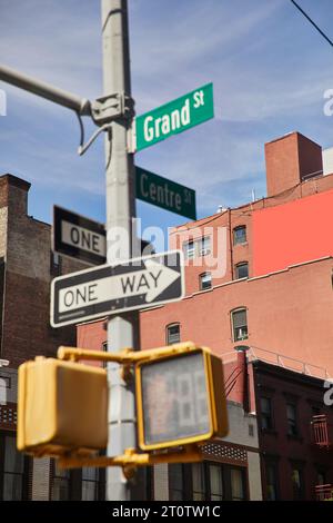 buildings and traffic signs showing directions on crossroad in new york city, urban signage Stock Photo