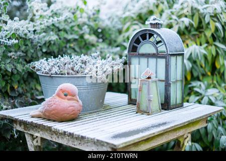 Frozen table with decoration. Sculpture of the bird and lanterns. Stock Photo