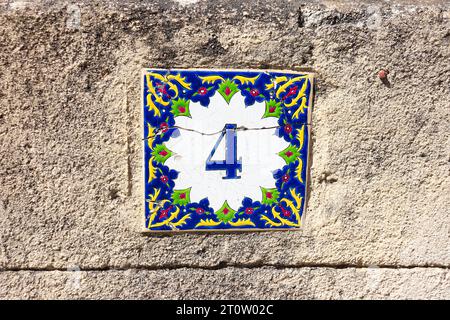 Greek style house number 4 (four) ceramic tile Stock Photo