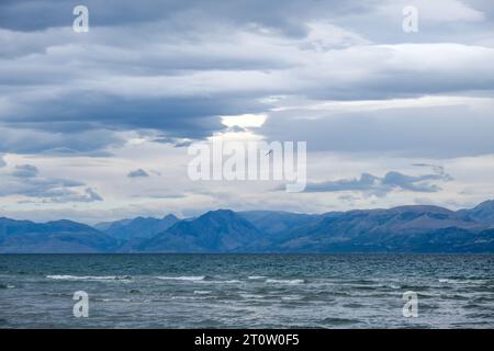 Kalamaki, Corfu, Greece - View from Kalamaki beach in the northeast of the Greek island Corfu over the Ionian Sea towards the mainland of Albania at t Stock Photo