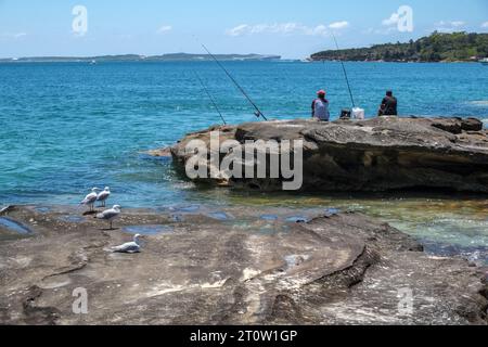 Anglers and seagulls at Jibbon Beach, Bundeena, Royal National Park, New South Wales, Australia Stock Photo