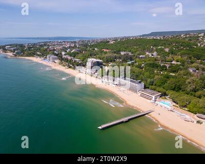 A stunning aerial top view of an exclusive residential complex nestled by the sea, boasting luxurious amenities and breathtaking oceanfront panoramas. Stock Photo