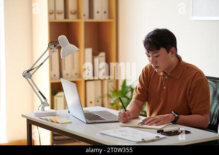 Pensive software engineer building conceptual model that defines structure, behavior, and more views of system Stock Photo