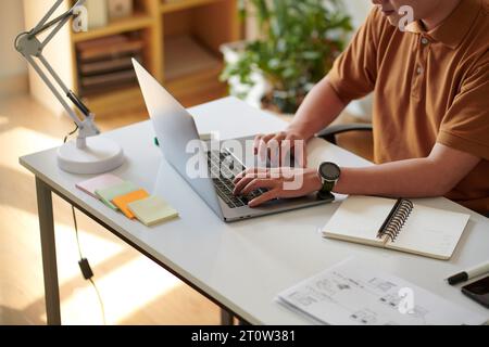 Cropped image of software developer working on project at desk in home office Stock Photo