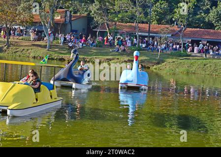 ity: Garça, Sao Paulo, Brazil, July 05, 2022: Paddle boating or rowing on the lake in Lago with tourists in the background with Brazilian flag, select Stock Photo