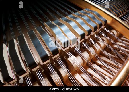 A picture of the piano hammers that are crucial component of the piano, and this image focuses on the beauty of their intricate design. These are resp Stock Photo