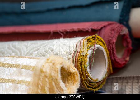 Rolls with decorative fabric for curtains and furniture upholstery material to choose the style for the interior design, copy space, selected focus, n Stock Photo