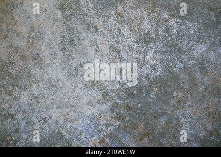 Rough gray concrete surface with some blue and beige speckles as grunge background texture for urban themes or architecture, full frame, copy space Stock Photo