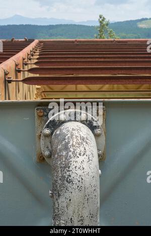 old or antique water steel piping system for large scale metal tanks for water supply treatment, industrial equipment concept taken in vertical orient Stock Photo