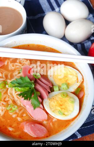 Photo of noodle soup with toppings such as sausages, eggs, and vegetables Stock Photo