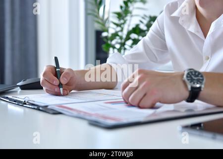 Young businessman analyzing financial report. Finance and trade concept. Close up Stock Photo