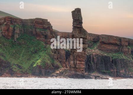 The Old Man of Hoy is a 449-foot-tall sea stack located on the west coast of the island of Hoy in Orkney, Scotland. Stock Photo