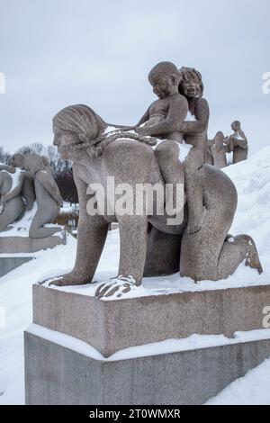 Sculptures by Gustav Vigeland at the Vigeland Installation in Frogner Park, Oslo, Norway. A mother playing with her two children Stock Photo