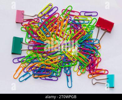Colrful metal paper clips and pins pile on white background Stock Photo