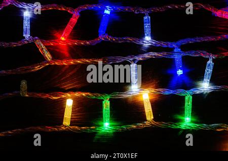Multi-colored New Year's garlands with LED lamps on wires. New Year's decor Stock Photo
