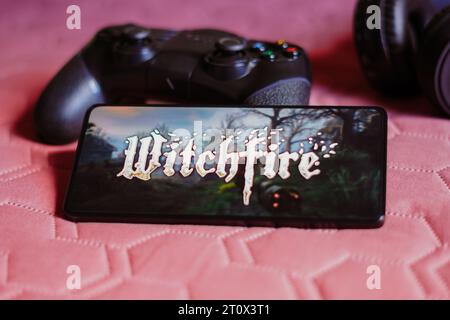 Brazil. 09th Oct, 2023. In this photo illustration, the Witchfire logo is displayed on a smartphone screen, next to a gamepad. Credit: SOPA Images Limited/Alamy Live News Stock Photo