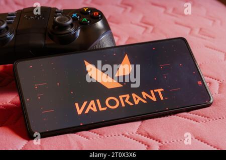 Brazil. 09th Oct, 2023. In this photo illustration, the Valorant logo is displayed on a smartphone screen, next to a gamepad. Credit: SOPA Images Limited/Alamy Live News Stock Photo