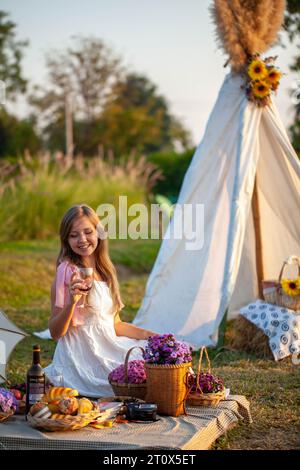 Woman in a white dress amidst a meadow Stock Photo