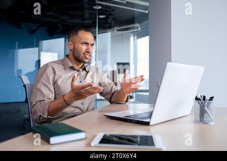 Upset frustrated businessman looking at laptop window, man received online notification message with bad achievement results, workplace error. Stock Photo