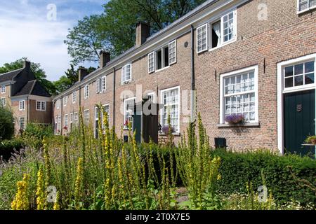 Courtyard of the beguinage (Begijnhof) in Breda, the Netherlands with herb garden and surrounded by 29 small houses Stock Photo