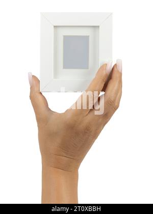Adult female hand with long square ombre manicured nails, holding up an empty photoframe with borders. Isolated on a white background. Stock Photo