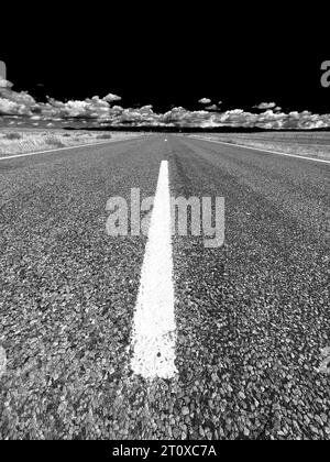 Dramatic black and white photograph of an empty rural highway Stock Photo