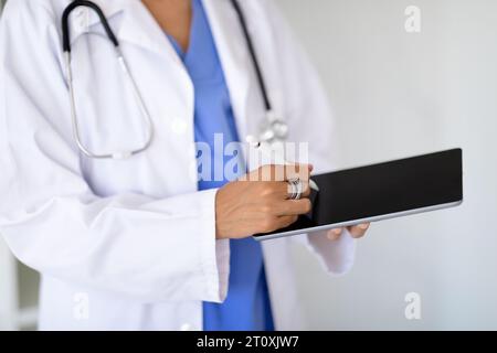 Unrecognizable doctor using tablet with black screen and stylus pen Stock Photo
