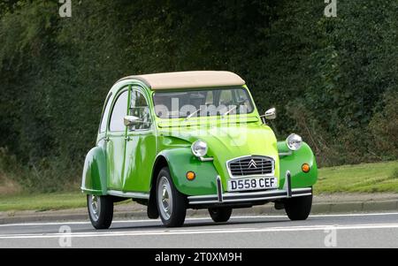 Bicester,Oxon.,UK - Oct 8th 2023: 1986 green Citroen 2CV classic car driving on an English country road. Stock Photo