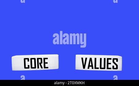 Text CORE VALUES written on wooden blocks and blue background Stock Photo