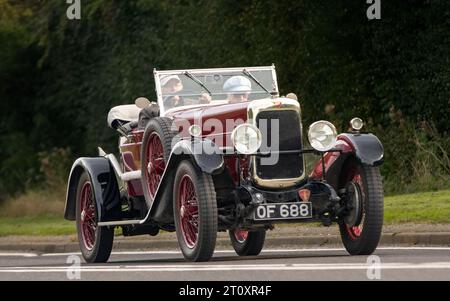 Bicester,Oxon.,UK - Oct 8th 2023: 1929 maroon Alvis Sports vintage car driving on an English country road. Stock Photo