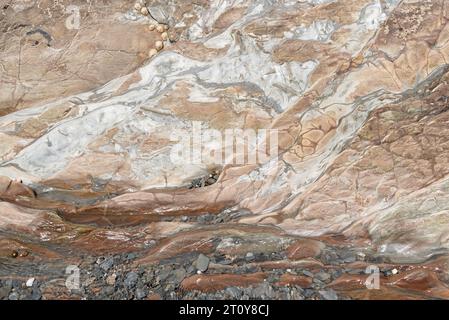 Pink rock formation on the beach in North Devon Stock Photo