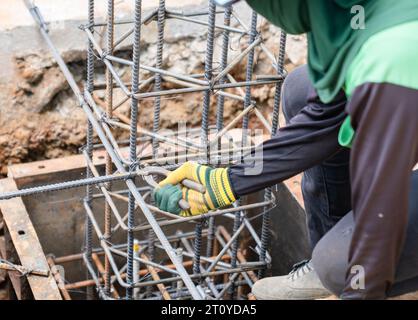 Worker wire bundle steel rod structure for pour concreat on formwork. Stock Photo
