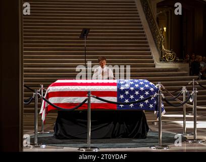 A woman places her hand on her heart while pausing in front of Senator Diane Feinstein's casket during the lying in state at City Hall. Stock Photo