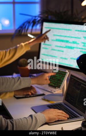 Programmers working in office at night, closeup Stock Photo