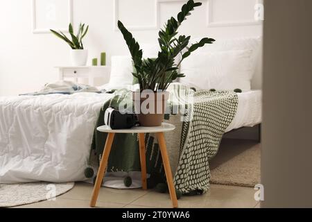 Interior of children's bedroom with VR glasses and houseplant on table Stock Photo