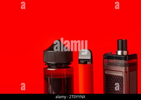 Disposable electronic cigarettes on red background close up Stock Photo