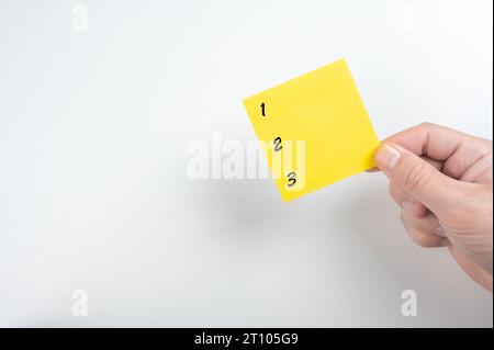 instruction mockup. 1, 2, and 3 order numbers on blank yellow sticky notes with copy space, priority, process, or instruction. plan point by point Stock Photo