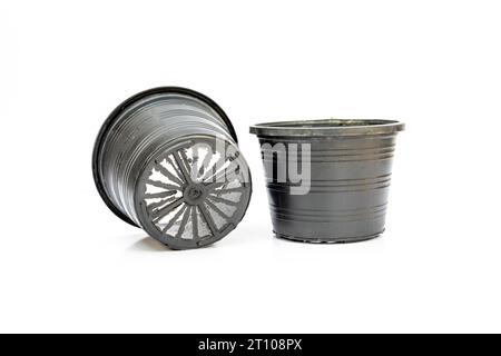 Black plastic pots for plants isolated on white background Stock Photo