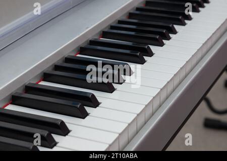 close-up of piano keys. close frontal view, black and white piano keys, viewed from above. Stock Photo