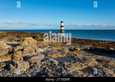 Penmon Point on the coast of Anglesey, North Wales. The famous Trwyn Du Lighthouse in morning sunlight. Stock Photo