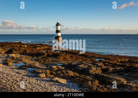 Penmon Point on the coast of Anglesey, North Wales. The famous Trwyn Du Lighthouse in morning sunlight. Stock Photo