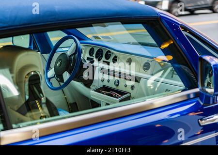 New York City, USA - July 7, 2023: 2008 Rolls-Royce Phantom Drophead Coupe blue car interior view from outside the passenger windows Stock Photo