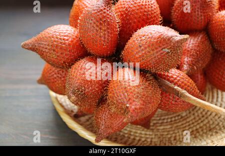 Clusters of Fresh Ripe Salak or Snakeskin Fruit in a Basket Stock Photo