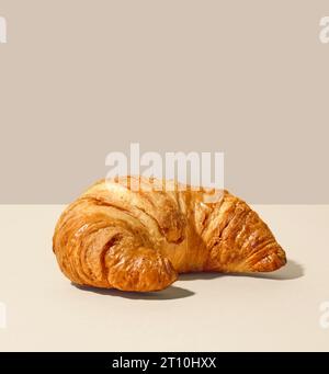 freshly baked butter croissant on beige background Stock Photo