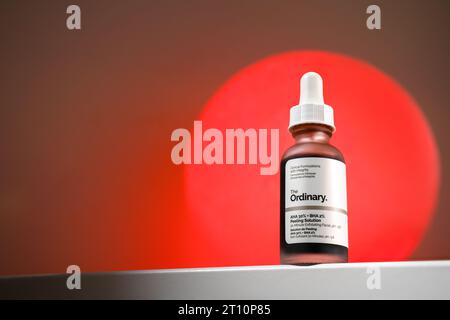 Strasbourg, France - September 2023: The Ordinary skincare brand by Deciem. AHA BHA Peeling Solution packaging against red moon. Clean minimalist high Stock Photo