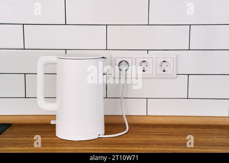 https://l450v.alamy.com/450v/2t10w71/white-stylish-electric-kettle-stands-on-a-wooden-kitchen-countertop-2t10w71.jpg