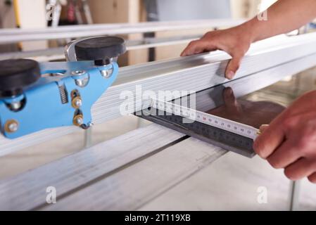 Construction worker cutting ceramic tiles using ceramic cutter Stock Photo