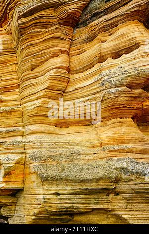 Hopeman Moray Coast Scotland the striated yellow and orange colours of the large cliffs of sandstone Stock Photo