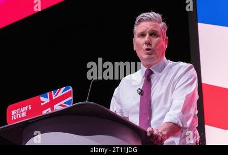 Protester covers  Keir Starmer with glitter during the start of the leaders speech.The protester was wrestled to ground and removed by security. Sir Keir Brushed his hair removed his jacket and carried on with speech. His shirt, hands and the floor around him was covered in glitter and remained so throughout the speech. Labour Conference 2023. Credit: GaryRobertsphotography/Alamy Live News Credit: GaryRobertsphotography/Alamy Live News Stock Photo