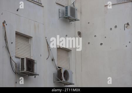 A wall house seen with bullet holes in the southern Israeli city of Ashkelon after a rocket attack from Gaza. Fighting between Israeli soldiers and Islamist Hamas militants continues in the border area with Gaza. Stunned by the unprecedented assault on its territory, a grieving Israel has counted over 700 dead and launched a withering barrage of strikes on Gaza that have raised the death toll there to 493 according to Palestinian officials. Stock Photo